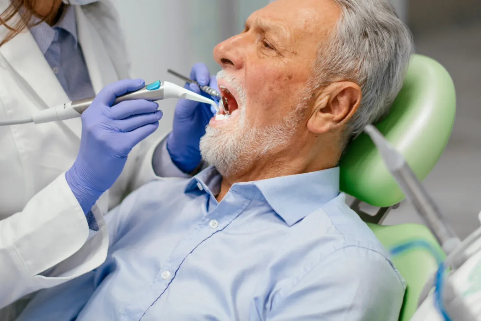 Patient receiving a dental examination ahead of All-on-6 implant treatment