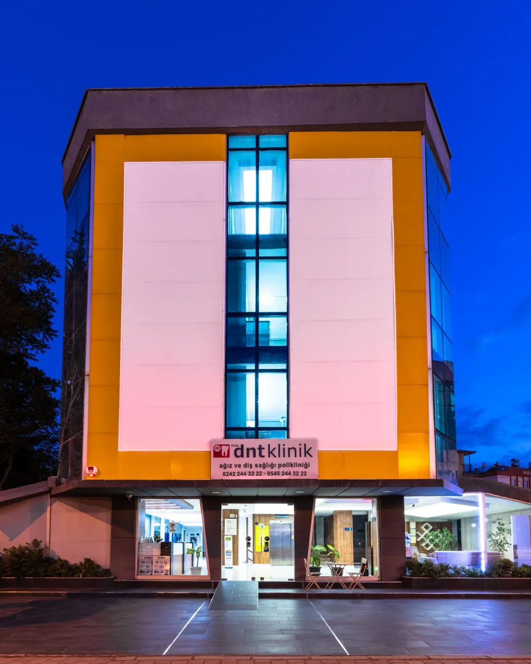 DNT Klinik building exterior at dusk in Antalya